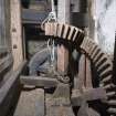 Interior. Ground floor. Milling area. Gear cupboard showing pit wheel, upright shaft and wallower.