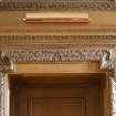 Interior.  Detail of carved wooden door frame entrance to Dining Room from Inner Hall