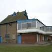 View from NNW showing later balcony and N gable of original building.