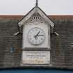 Detail of clock and memorial inscription at Edinburgh Academicals Cricket and Rugby Ground, from WNW