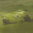 Oblique aerial view centred on the remains of henge and cairn, taken from the SW.