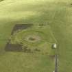 Oblique aerial view centred on the remains of henge and cairn, taken from the N.
