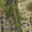 Oblique aerial view centred on the remains of the station with the station house adjacent, taken from the E.