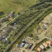 Oblique aerial view centred on the remains of the station with the station house adjacent, taken from the NE.