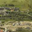 Oblique aerial view centred on the remains of the station with the station house adjacent, taken from the N.