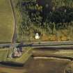 Oblique aerial view centred on the remains of the windmill, taken from the SSE.