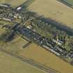 Oblique aerial view centred on the former hospital with East Fortune farmstead adjacent, taken from SE.