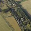 Oblique aerial view centred on the former hospital and First World War military camp with East Fortune farmstead adjacent, taken from ESE.