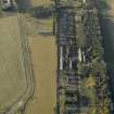 Oblique aerial view centred on the former hospital with East Fortune farmstead adjacent, taken from E.