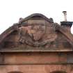 Detail of pediment with coat of arms above main entrance