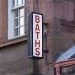Detail of 'Baths' sign outside main entrance to Victoria public baths on Junction Place, Edinburgh.