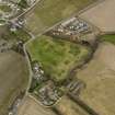 General oblique aerial view centred on the orchard and the remains of the rig with the smallholding, cottages and poultry houses adjacent, from the SSW.