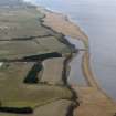 General oblique aerial view looking along the coast and centred on the reed beds, taken from the SW.