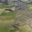 General oblique aerial view centred on the field boundaries with the town adjacent, taken from the ESE.