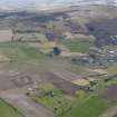 General oblique aerial view centred on the field boundaries with the golf course and town adjacent, taken from the NNE.