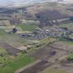 General oblique aerial view centred on the field boundaries with the golf course and town adjacent, taken from the NE.