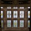 Interior. Ground floor. Hall.  E side stained glass window. Detail