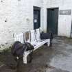 Stable block. Courtyard. Bench with pony saddles. Detail