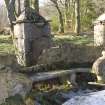 Gatepiers and carved bench. Detail