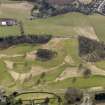 Oblique aerial view centred on the golf course with the dovecot, stable and lodge adjacent, taken from the NNW.
