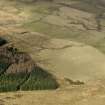 Oblique aerial view centred on the remains of rig and furrow cultivation, taken from the SE.