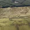 Oblique aerial view centred on the remains of rig and furrow cultivation, taken from the N.