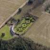 Oblique aerial view centred on the walled garden and estate cottage, taken from the NW.