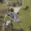 Oblique aerial view centred on the house with the walled garden adjacent, taken from the W.
