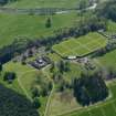 Oblique aerial view centred on the walled garden with the stable block adjacent, taken from the N.