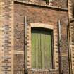 Detail of door. Note the yellow brick dressing of the doors and window and the strip pilasters