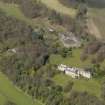 Oblique aerial view centred on the house with the stable block adjacent, taken from the SE.