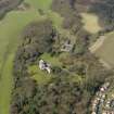 General oblique aerial view centred on the house with the stable block adjacent, taken from the E.