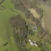 General oblique aerial view centred on the house with the stable block adjacent, taken from the SE.