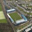 Oblique aerial view centred on the football ground, taken from the SSW.