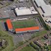 Oblique aerial view centred on the football ground, taken from the W.