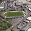 Oblique aerial view centred on the greyhound stadium, taken from the W.