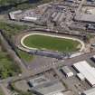 Oblique aerial view centred on the greyhound stadium, taken from the SW.