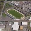 Oblique aerial view centred on the greyhound stadium, taken from the SSW.