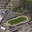 Oblique aerial view centred on the greyhound stadium, taken from the SE.