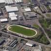 Oblique aerial view centred on the greyhound stadium, taken from the NE.