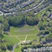 Oblique aerial view centred on the remains of the football ground, taken from the N.