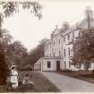 View of entrance front, Kinnaird House with two women and children in the foreground.
