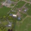 Oblique aerial view centred on the aircraft hangars with Hatton House adjacent, taken from the SSW.