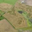 Oblique aerial view of the cropmarks of the pits, rig and furrow and field boundaries, taken from the SW.