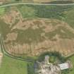 Oblique aerial view of the cropmarks of the pit defined avenue and cursus and the barrow at Kirkmabreck, taken from the SW.