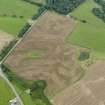 Oblique aerial view of the cropmarks of the palisaded settlements, possible enclosure and the remains of the motte at Balgreggan, taken from the NE.