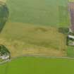 Oblique aerial view centred on the cropmarks of the rig and furrow and possible pits, taken from the S.