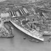 RMS Queen Mary, under construction in John Brown's shipyard, Clydebank. Oblique aerial view of the liner, from SW.