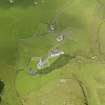 Oblique aerial view centred on the church, cemetery, manse and house at Kilchoman, Islay, taken from the SE.