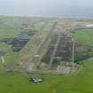 General oblique aerial view looking down the main runway at Machrihanish Airfield, taken from the E.